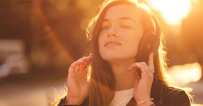 Young woman outdoors wearing headphones