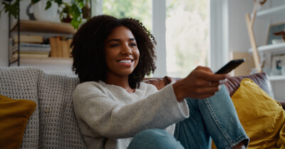 Young woman with TV remote control