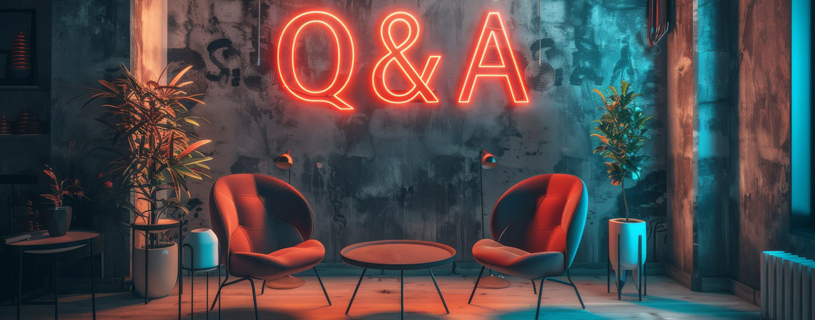 Studio set with two chairs with Q&A neon on wall