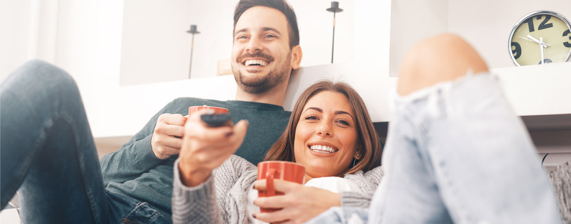 Couple watching TV at home